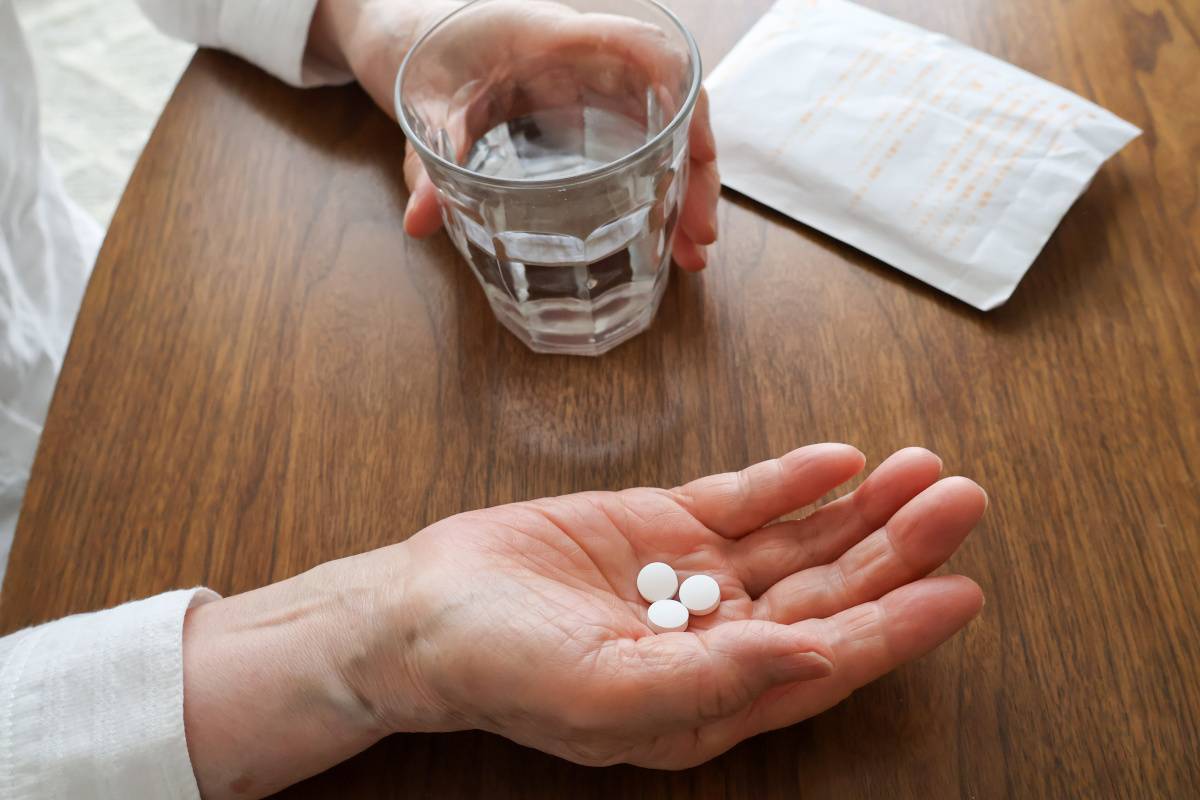 薬を飲む女性の手元
