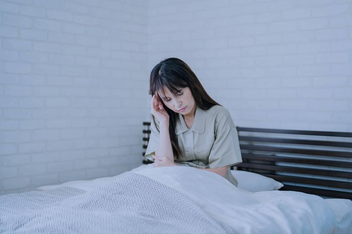 頭を押さえる女性